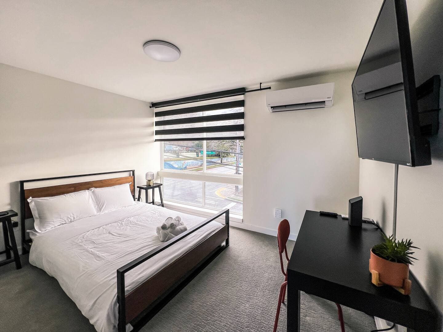 The Horizon Suite, a top-floor bedroom with en-suite bath and a large window